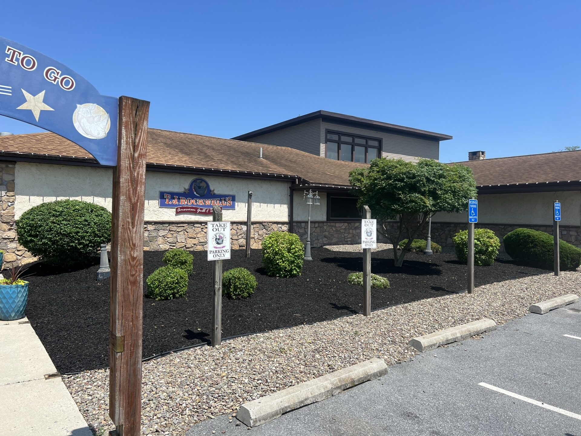 Commercial property frontage with black mulch beds and trimmed shrubs, landscaping near Newville PA